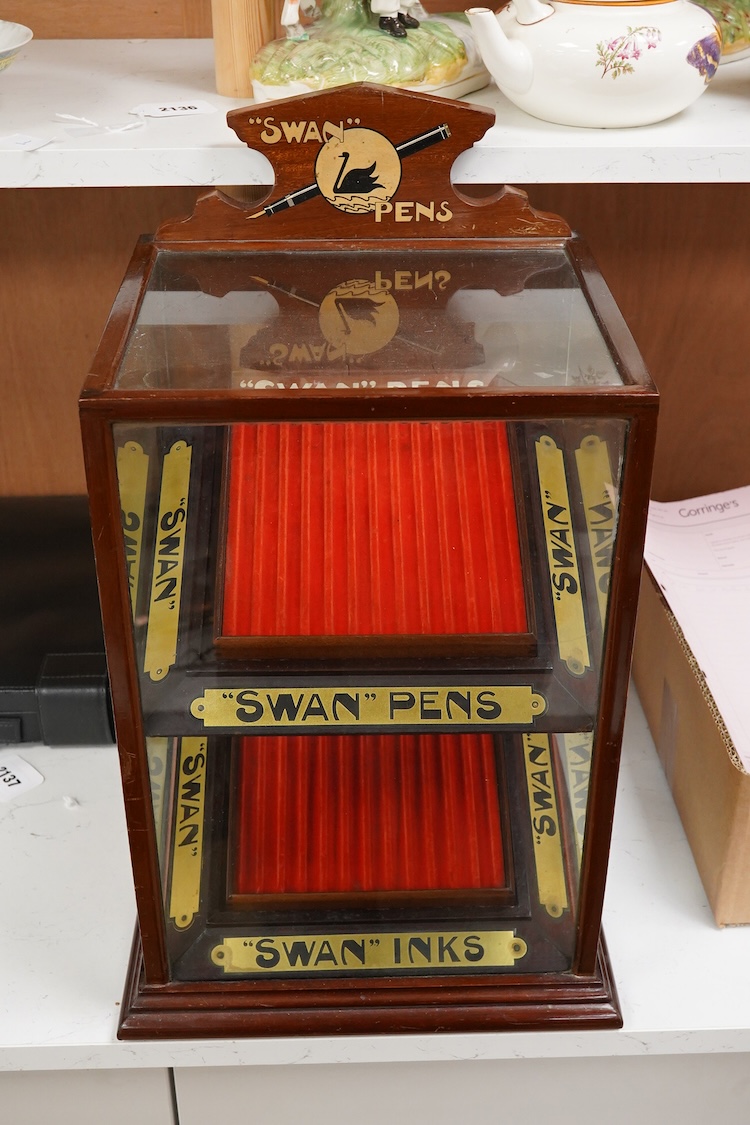 A rare complete Mabie Todd & Co. Swan pen cabinet with original signage and trays to hold twenty four pens, with key for lockable rear door